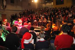 A packed theatre enjoy carols