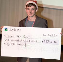 Ollie Cole with the cheque for Jeans for Genes