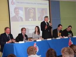 Gerald Howarth MP, addresses the audience, while the Chair, Frances McDonnell, looks threateningly at Jonathan Slater as he tries to interrupt.