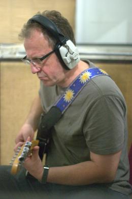 Principal Simon Jarvis on guitar